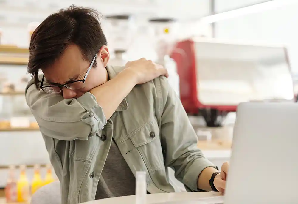 a person coughing and sneezing